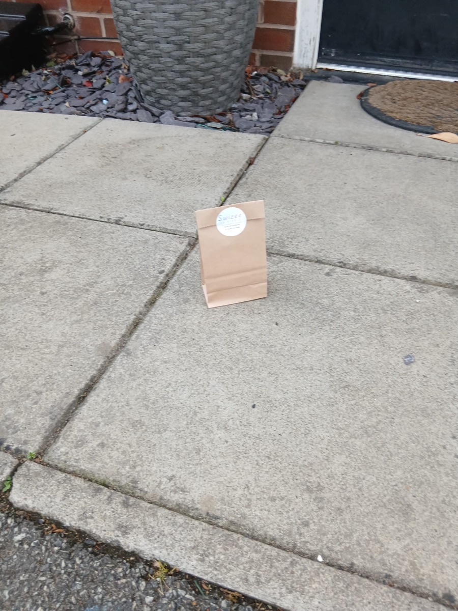 A Swizee order in a paper bag on a doorstep